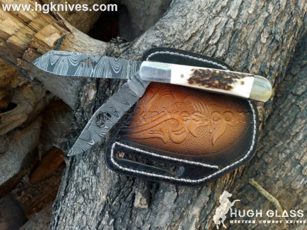 Custom Damascus Trapper Knife with twist-pattern steel, clip and spey blades, and stag antler handle.