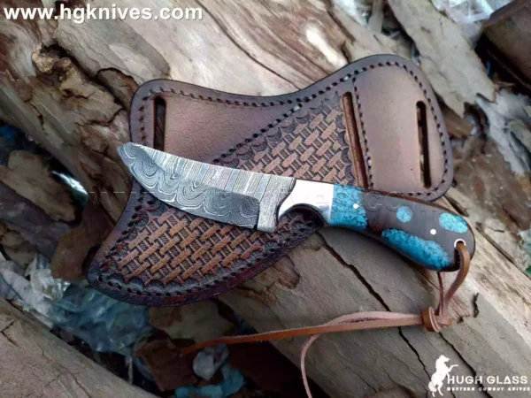 Hand-forged Cowboys knife with Damascus steel twist pattern blade and hybrid rosewood resin handle.