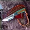 Custom Cowboy Knife with hand-forged Damascus steel blade and unique Pine Cone handle, shown next to the Pancake style cross-draw leather sheath.